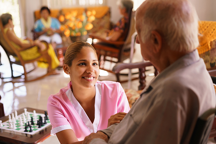 Nurse giving senior man prescription drugs