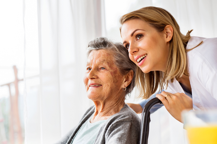 Caregiver with senior patient in wheel chair